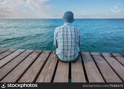 Man relaxing on sea pier