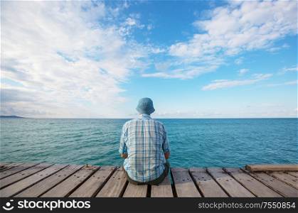 Man relaxing on sea pier
