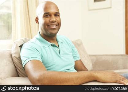 Man Relaxing On Sofa At Home