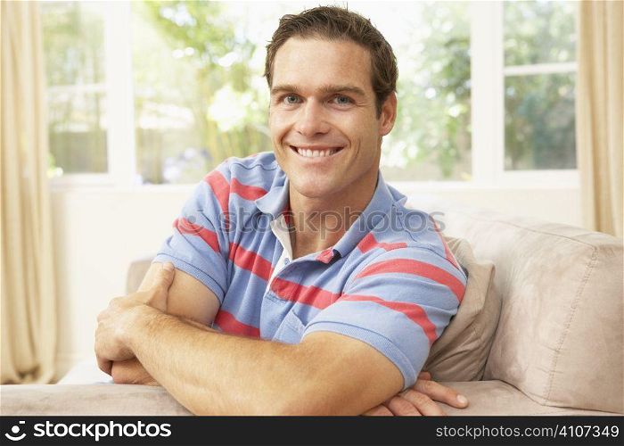 Man Relaxing On Sofa At Home