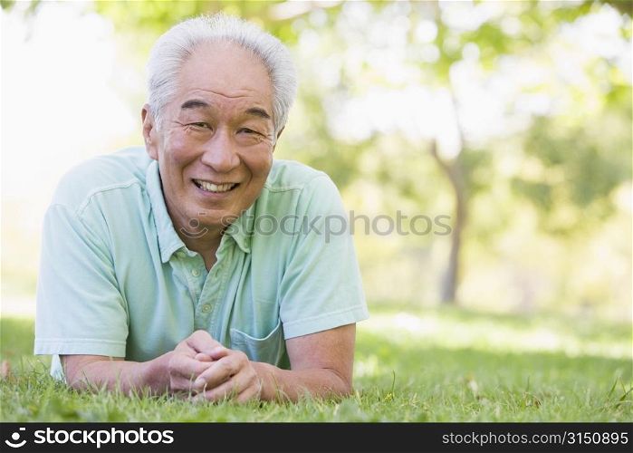 Man relaxing outdoors smiling