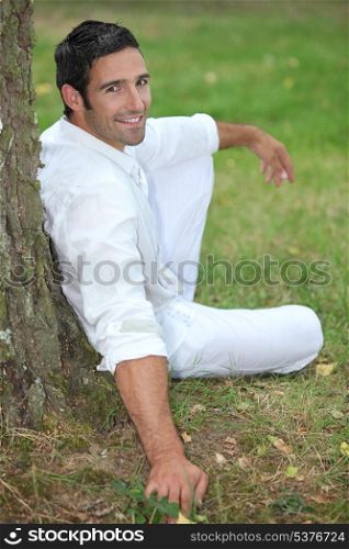 Man relaxing under a tree
