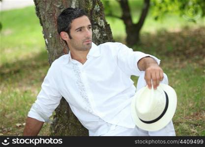 Man relaxing under tree