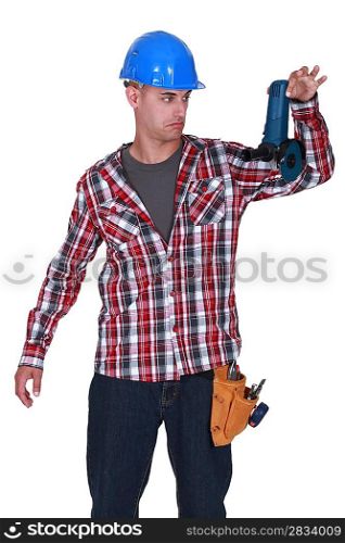 Man reluctantly holding angle grinder