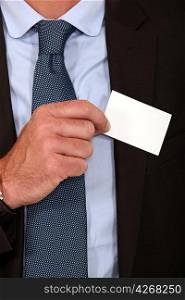 Man removing business card from pocket