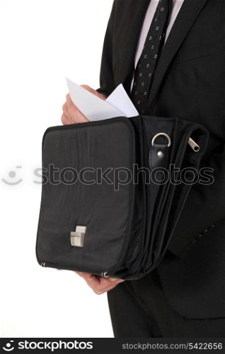 Man removing document from briefcase