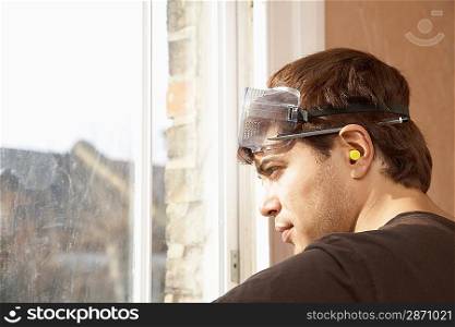 Man Renovating Room Looking Out Window