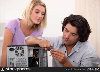 man repairing a computer