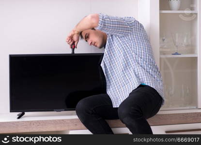 Man repairing broken tv at home