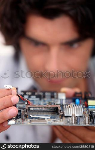 Man repairing circuit board