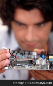 Man repairing circuit board