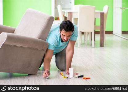 Man repairing furniture at home