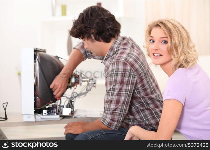 Man repairing television
