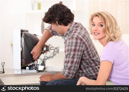 Man repairing television