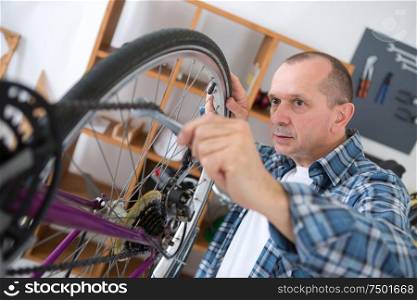 man reparing bike in the bicycle repair shop