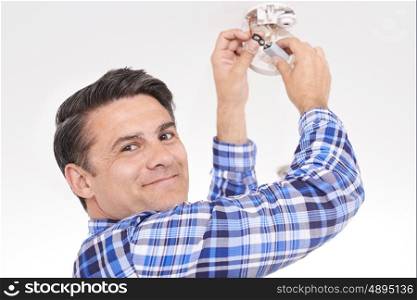 Man Replacing Battery In Home Smoke Alarm