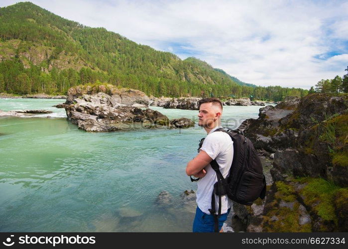 Man resting at river in Altai Mountains territory. Man resting at river