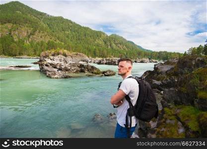 Man resting at river in Altai Mountains territory. Man resting at river
