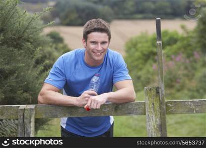 Man Resting During Run In Countryside