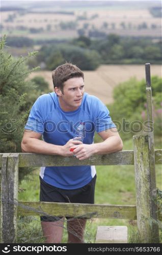 Man Resting During Run In Countryside