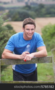 Man Resting During Run In Countryside