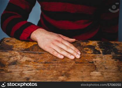 Man resting his hand on table