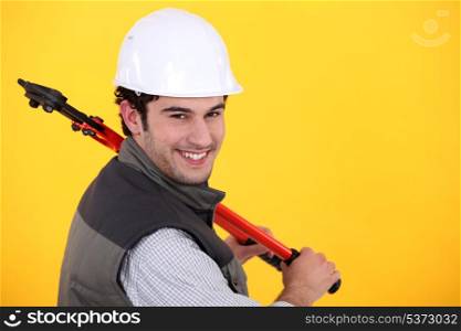 Man resting large bolt cutters over shoulder
