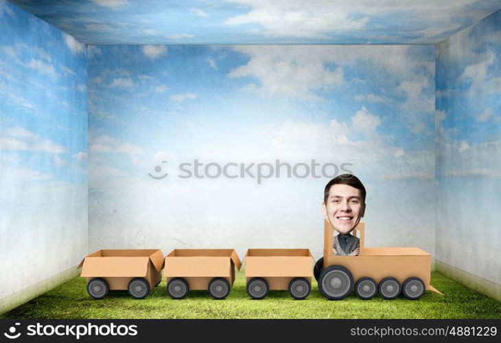 Man ride paper train . Funny cartoon image of businessman riding carton box