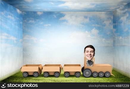 Man ride paper train . Funny cartoon image of businessman riding carton box