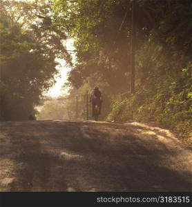 Man riding a bike on road in Costa Rica