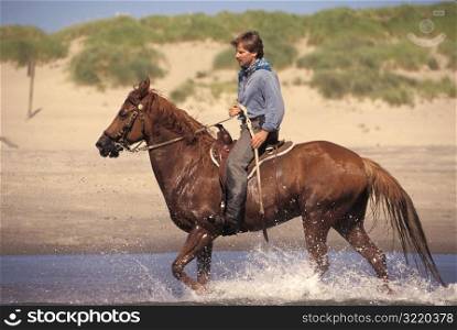 Man Riding a Horse Through Water