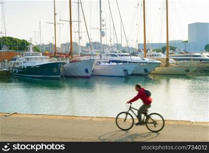 Man riding bicycle at Barcelona Port Vell. motion blur