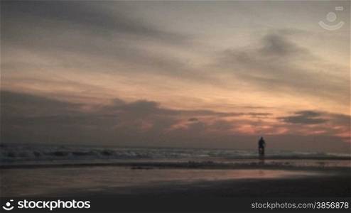 Man Riding Bicycle on Beach at Sunrise Summer. Themes: vacation, romance, summer, lifestyle, exercise, outdoors, exploring, romance, travel, destinations