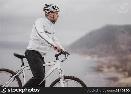 man riding bike cold day looking away with copy space