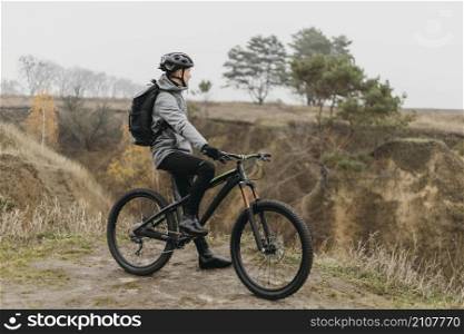 man riding bike mountain path