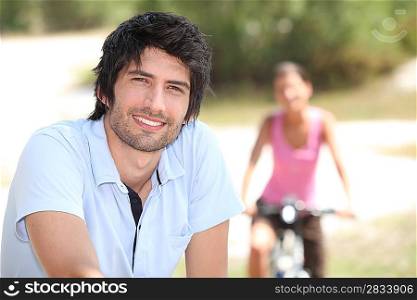 man riding bike outdoors and blurry background and woman riding bike