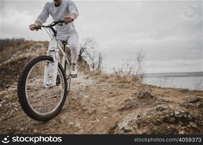 man riding bike outdoors with copy space