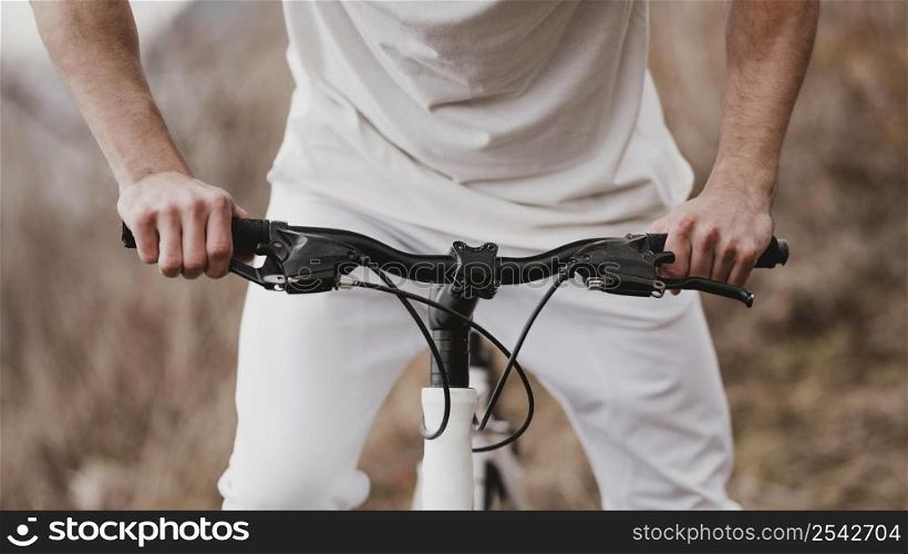 man riding bike white clothes