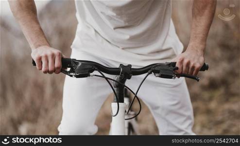 man riding bike white clothes