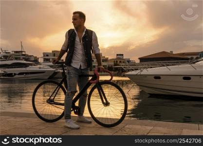man riding his bike sunset