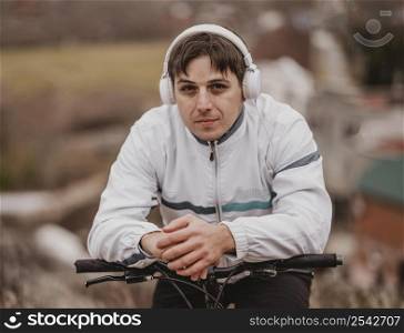 man riding his bike while listening music headphones