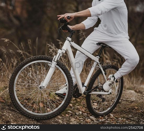 man riding his bike white clothes