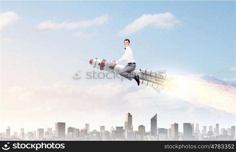 Man riding missile. Young businessman flying in sky on space rocket