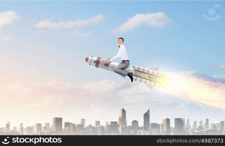 Man riding missile. Young businessman flying in sky on space rocket