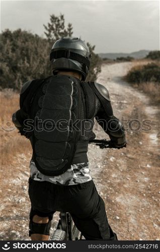 man riding mountain bike back view