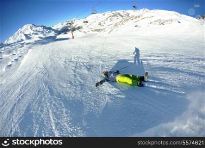 Man riding on skis fall down, he could break something at danger crash accident