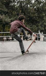 man riding skateboard outdoors park