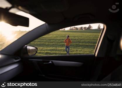 man road trip outdoors seen from inside car