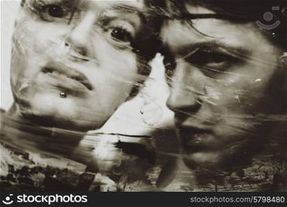 man&rsquo;s and woman&rsquo;s faces at a dirty muddy glass closeup