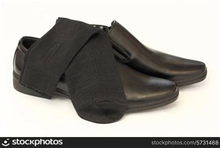 man&rsquo;s black shoes and socks isolated on white background